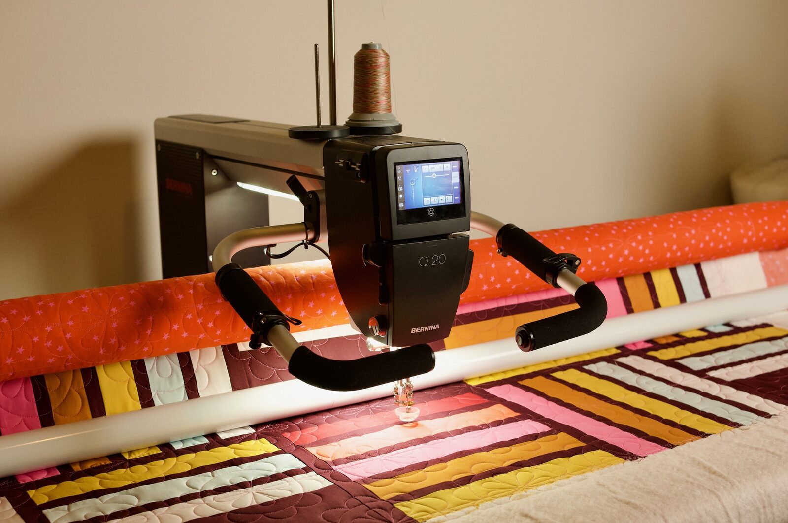 Bernina Q20 longarm machine quilting a striped color-block quilt