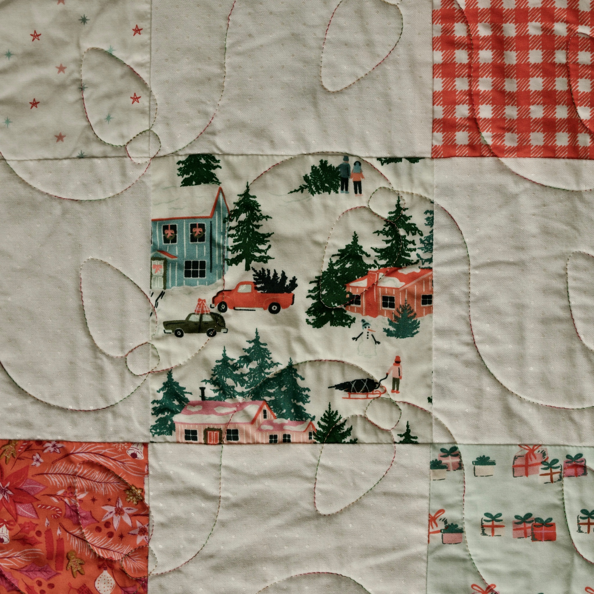 Green pine tree and ornament novelty prints pieced into cream and orange patchwork