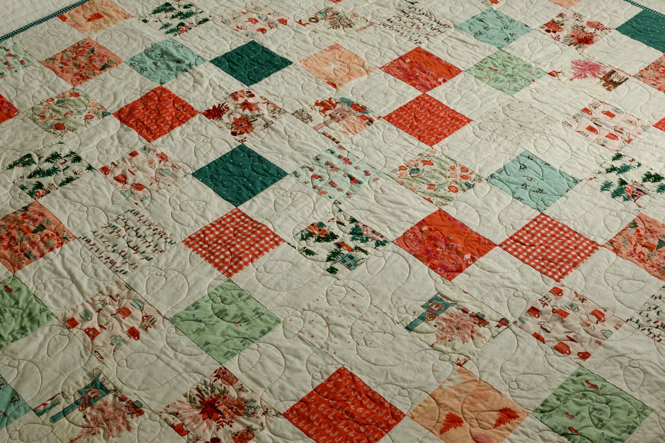 Candy cane, gingham, and cabin novelty prints in a holiday patchwork quilt