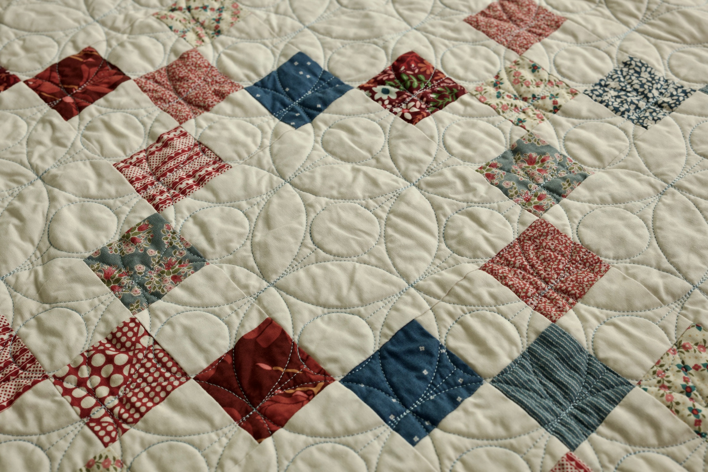 Diagonal view of red and blue floral patchwork squares