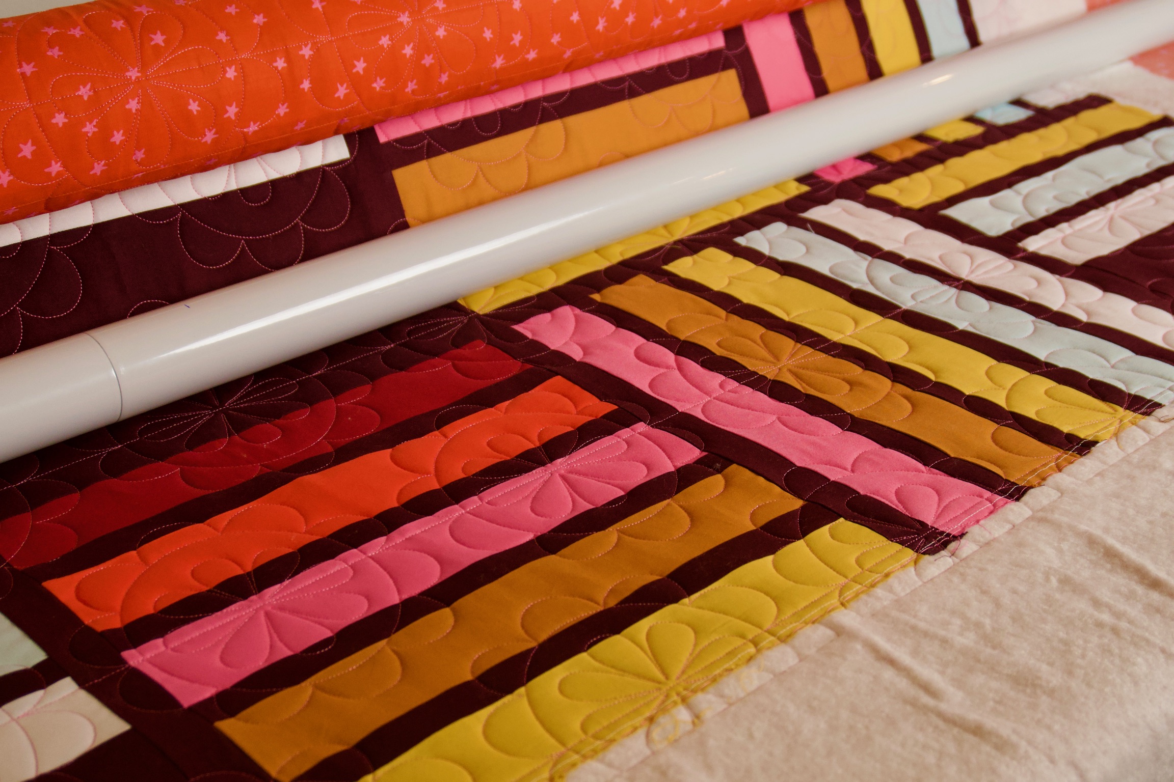 Quilt stripe texture in pink, orange, mustard, and cream